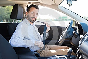 Mid Adult Owner Wearing Safety Belt In Car