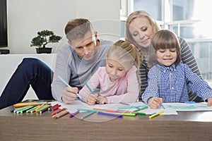 Mid adult parents with children drawing together at home