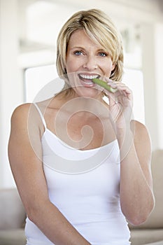 Mid Adult Woman Eating Celery Stick