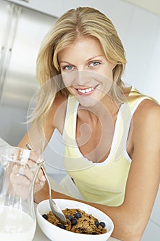 Mid Adult Woman Eating Cereal With Fruit