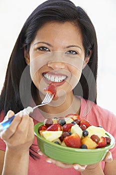 Mid Adult Woman Eating Fresh Fruit Salad