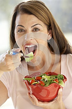 Mid Adult Woman Eating A Fresh Green Salad