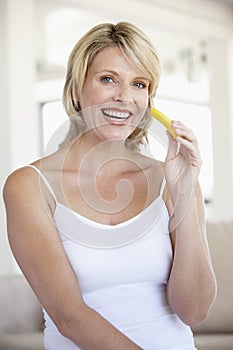 Mid Adult Woman Eating Pineapple