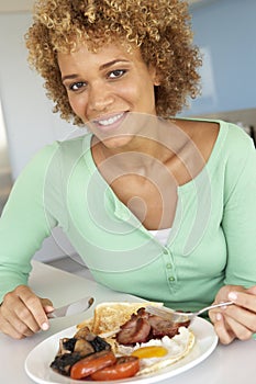 Mid Adult Woman Eating Unhealthy Fried Breakfast