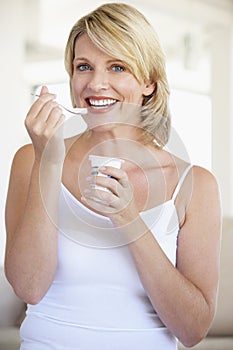 Mid Adult Woman Eating Yogurt