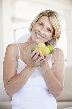 Mid Adult Woman Holding Fresh Fruit