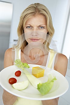 Mid Adult Woman Holding A Plate Of Healthy Food