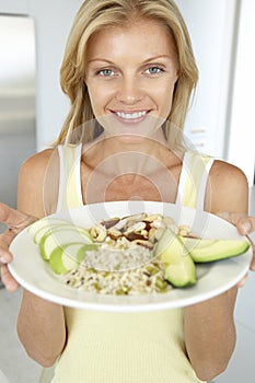 Mid Adult Woman Holding Plate With Healthy Foods
