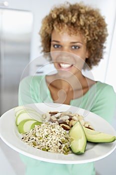 Mid Adult Woman Holding Plate With Healthy Foods