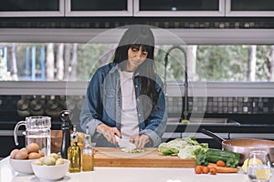 Mid adult woman housewife preparing fresh salad