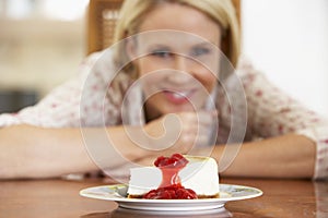 Mid Adult Woman Looking At Cheesecake