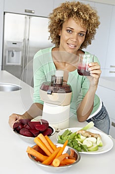 Mid Adult Woman Making Fresh Vegetable Juice