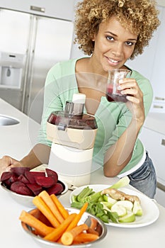 Mid Adult Woman Making Fresh Vegetable Juice