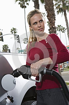Mid Adult Woman Refueling Her Car