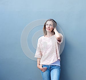 Mid adult woman smiling with hand in hair