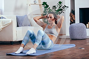 Mid adult woman training abdominals at home