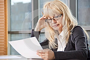 Mid adult woman work with documents photo