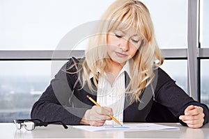 Mid adult woman work with documents