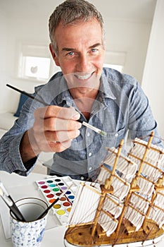 Mid age man painting model