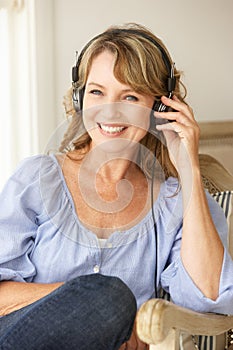 Mid age woman listening to music