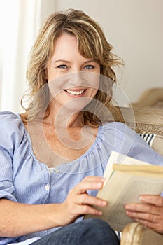 Mid age woman reading a book