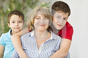 Mid-age woman with two boys indoor