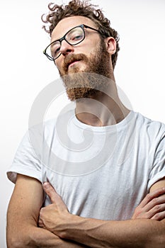 Mid - aged proud satisfied man with crossed arms looking at camera.