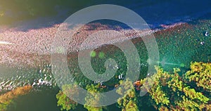 Mid air flight over fresh and clean mountain river at sunny summer morning. Vertical movement