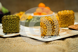 Mid-Autumn Festival moon cake, colorful food and drink on burlap background