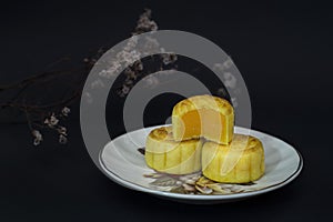 Mid Autumn Festival moon cakes with custard filling on black background