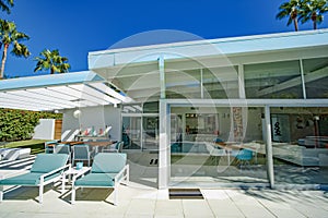 Mid-Century Modern Home Back Patio with View of Inside through Floor to Ceiling Glass View