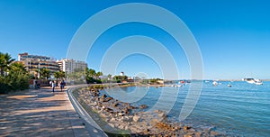 Mid morning sun on the beach city. Warm sunny day along the beach in Ibiza, St Antoni de Portmany Balearic Islands, Spain