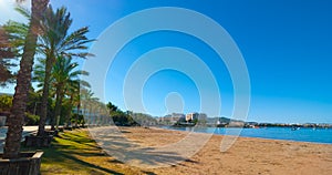 Mid morning sun on the beach city. Warm sunny day along the beach in Ibiza, St Antoni de Portmany Balearic Islands, Spain