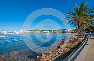 Mid morning sunny walk along Ibiza waterfront. Warm day on the beach in St Antoni de Portmany Balearic Islands, Spain