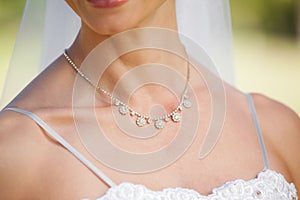 Mid section of a beautiful bride wearing a necklace