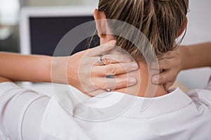 Mid section of businesswoman suffering from neck ache