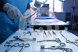 Surgeon holding surgical instrument in operating room of hospital photo