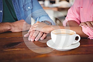 Mid-section of couple holding hands