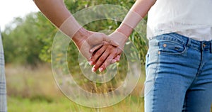 Mid-section of couple holding hands in olive farm 4k