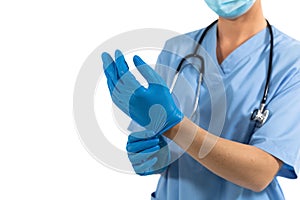 Mid section of female surgeon wearing protective gloves against white background