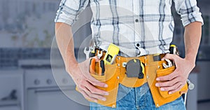 Mid-section of handy man with tool belt photo