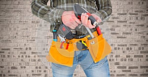 Mid section of handy man with tools and drill