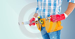 Mid section of handyman with tool belt and spirit level