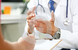 Mid section of male doctor explaining treatment plan to patient in his office. Physical, exam, er, disease prevention