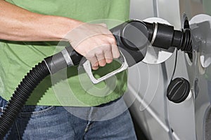 Mid Section Of A Man In Casuals Refueling His Car