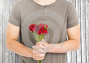 Mid-section man holding bunch of red roses