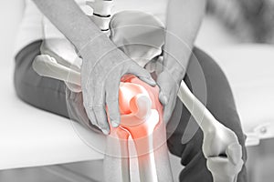 Mid section of man suffering with knee inflamation