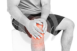 Mid section of man suffering with knee pain