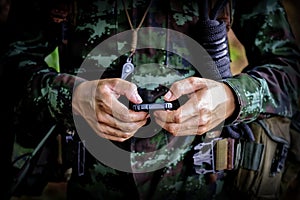 Mid section of military soldier using mobile phone in boot camp