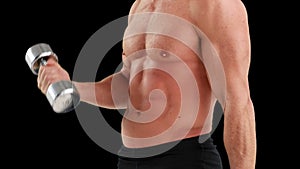 MId section of muscular man lifting dumbbells